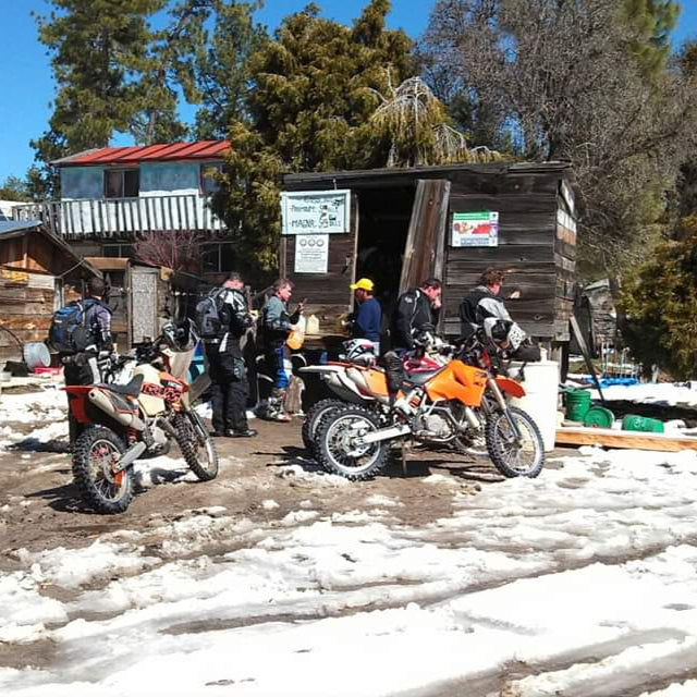 Baja dirt bike ride in the pine forest with snow.