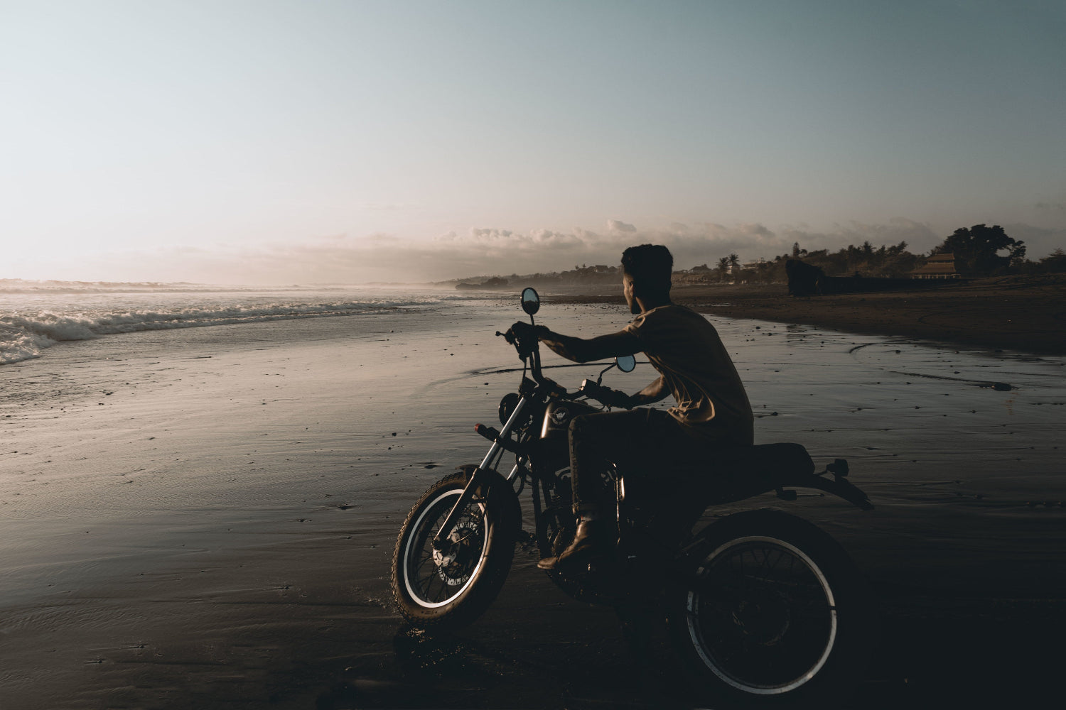 Motorcycle on wet beach sand